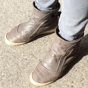 A pair of beige ankle boots with tapering toes and slightly raised heels.