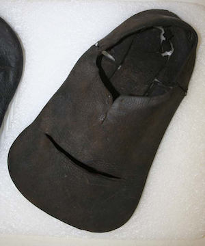 A brown leather unlisted shoe with a toe area so wide the shoe looks like a shovel shape when seen from above.